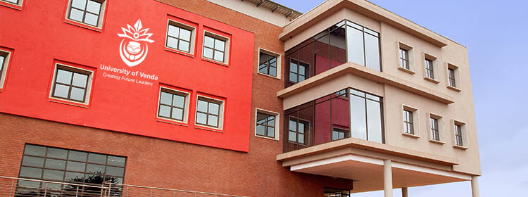Exterior of the University of Venda campus building with a red facade displaying the UNIVEN logo and motto Creating Future Leaders
