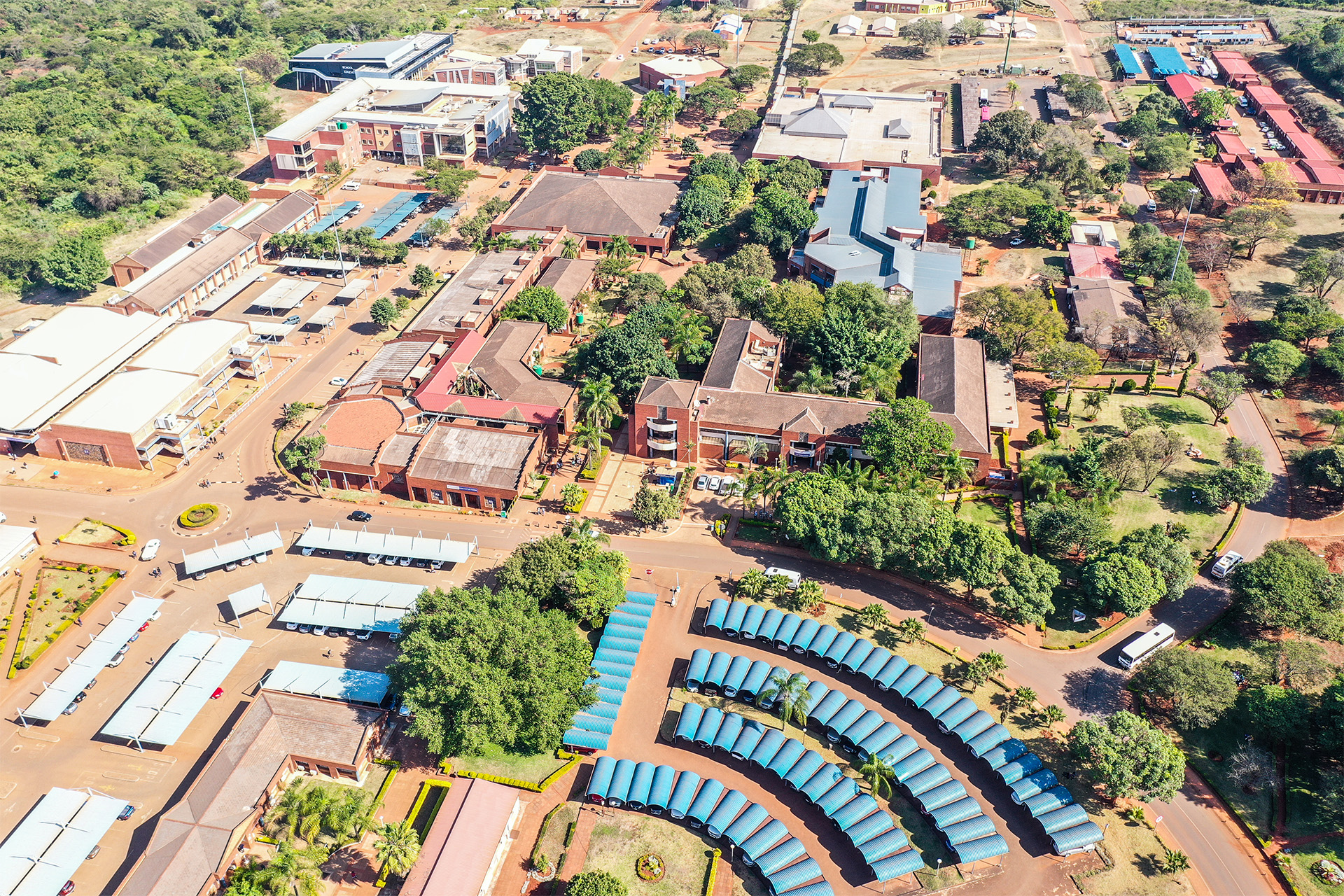 Aerial drone view of the University of Venda campus with academic buildings, parking lots and green trees