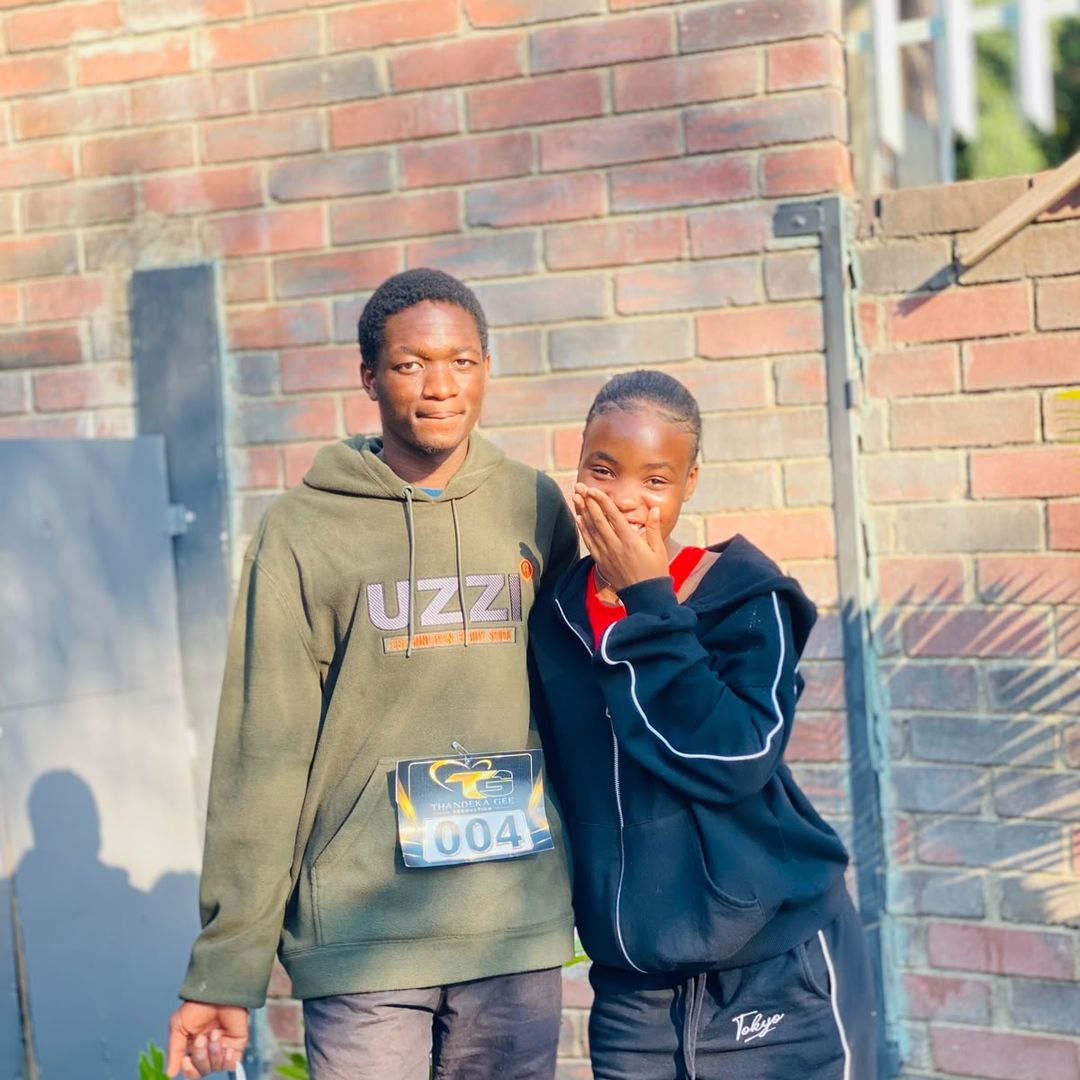 Sphesihle Nonyane wearing audition number 004 while standing with a woman at the Thandeka Gee Production 2026 auditions.